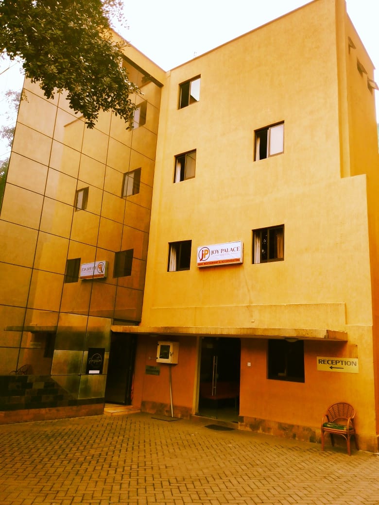 Hidden Gem hotel exterior with reception signage